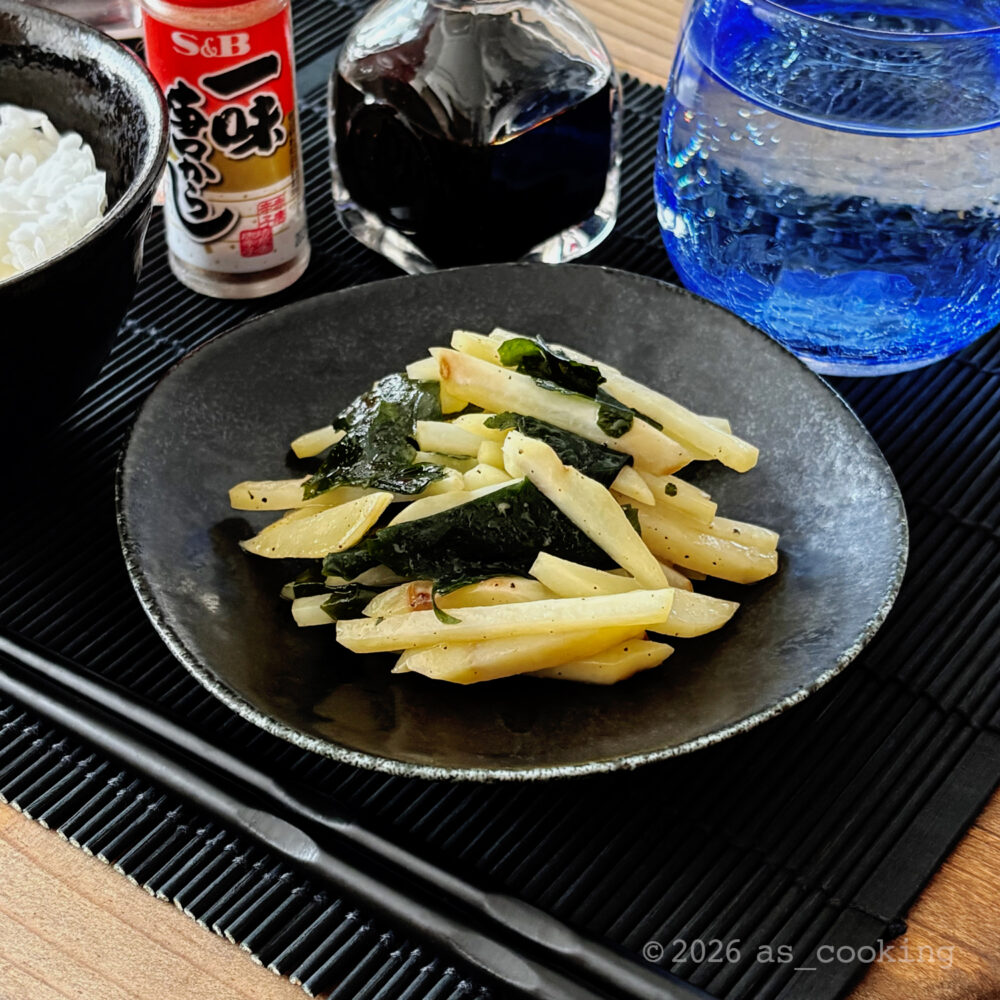 お皿に綺麗に盛り付けられた千切りじゃがいもと生わかめのバター醤油炒め